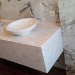 Столешница из искусственного камня с высокими бортами для ванной комнаты изготовлено в правила камня