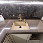 Угловая столешница из кварцевого агломерата коричневого цвета изготовлено в правила камня